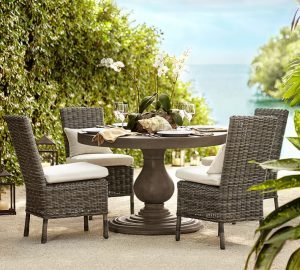 A concrete table with wicker chairs