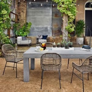 A wood table with wicker chairs